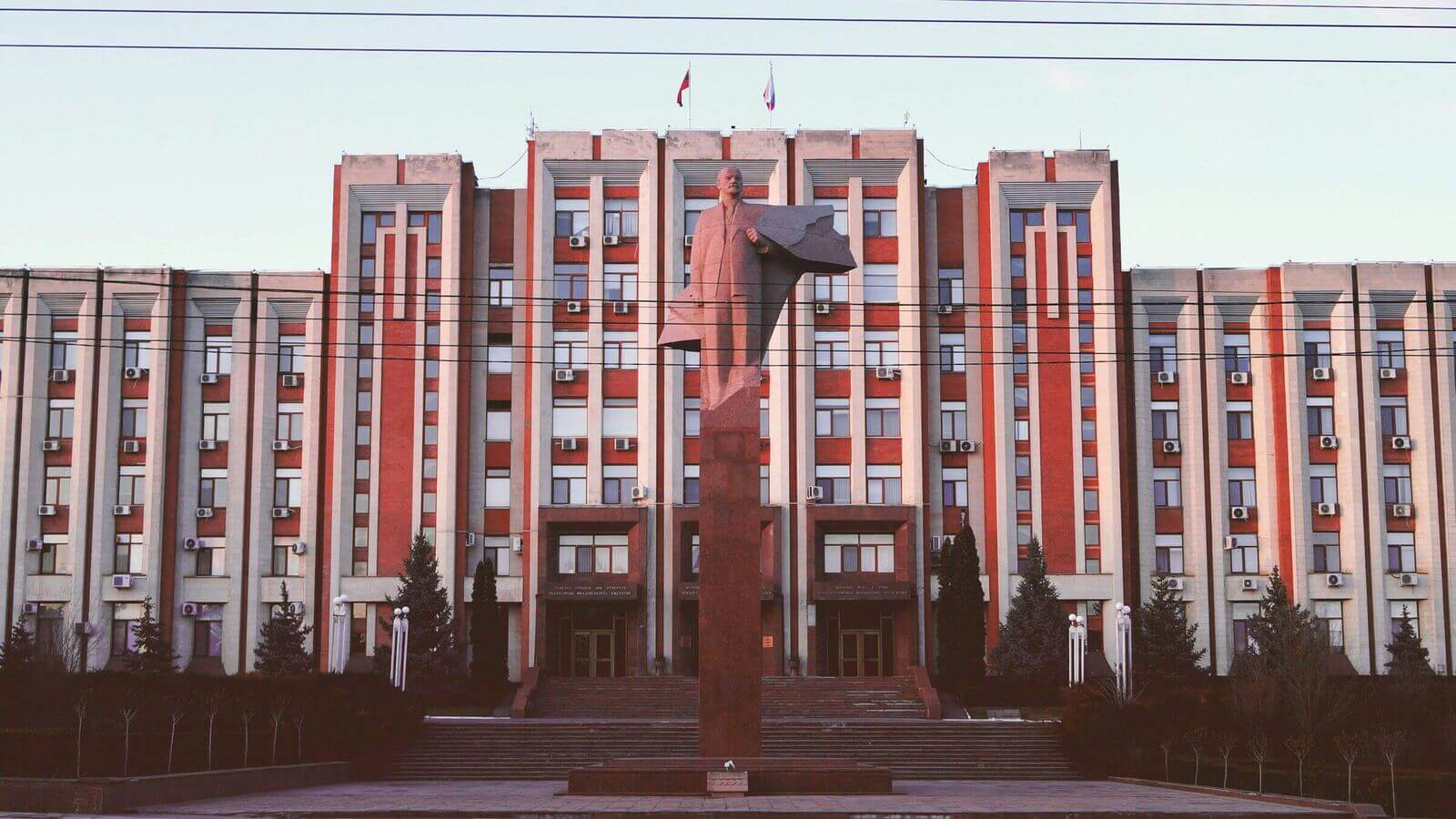 Long modernist Tiraspol facade with rows of narrow windows along the central boulevard.